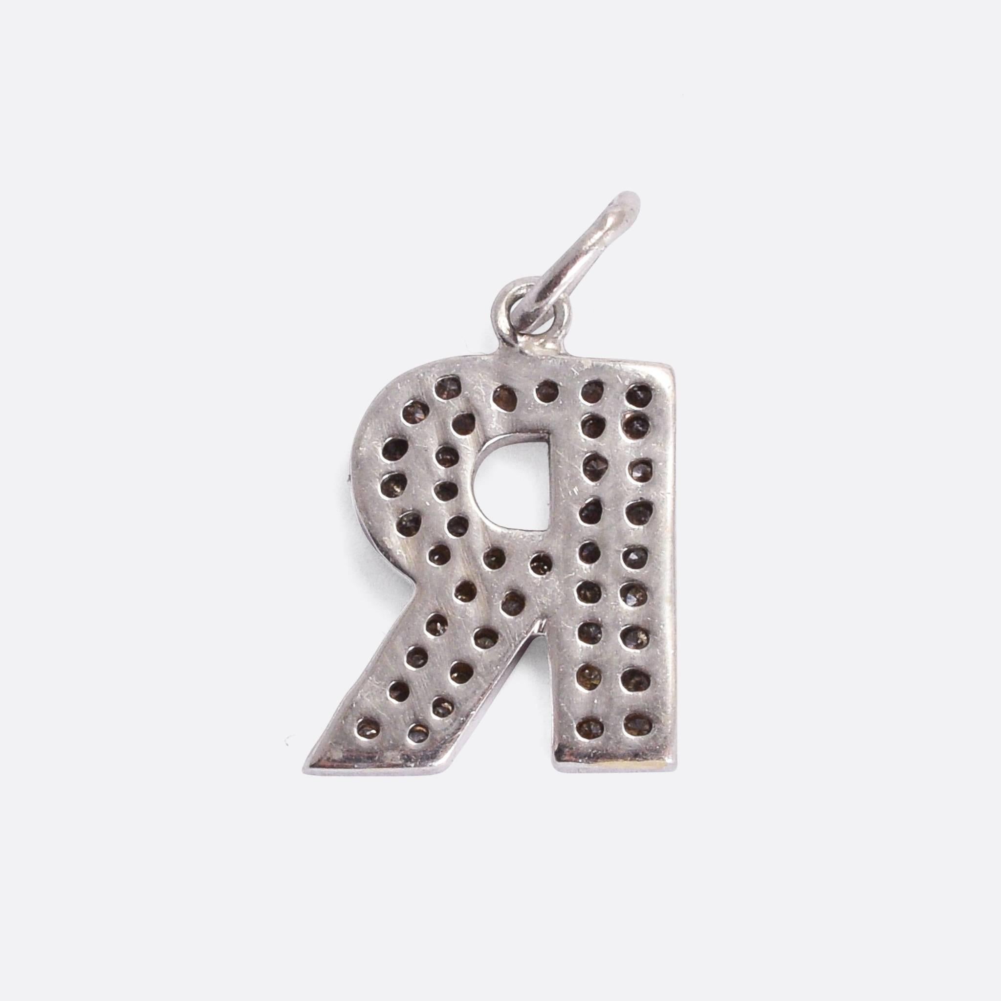 A fine vintage pendant modelled as the initial R, and set with 40 sparkling white diamonds. It's crafted from 18 karat white gold throughout, and looks great worn on a fine chain, or as an addition to your charm bracelet.

STONES
40 white diamonds