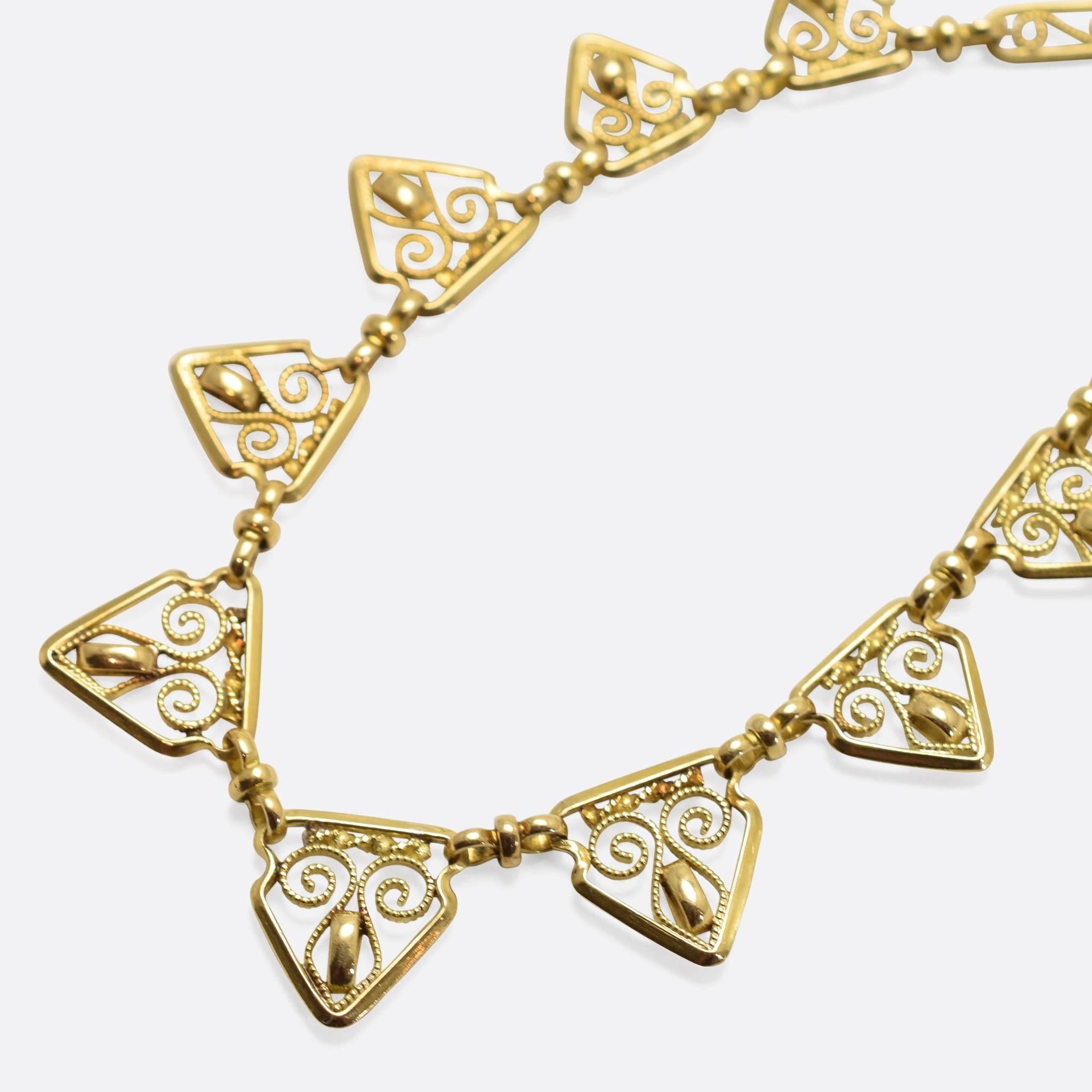 An exceptionally beautiful French necklace dating to the late Victorian period, circa 1900. The piece features wonderfully openworked links: graduated triangles with ropework innards at the front, and oval links around the back of the neck. Modelled