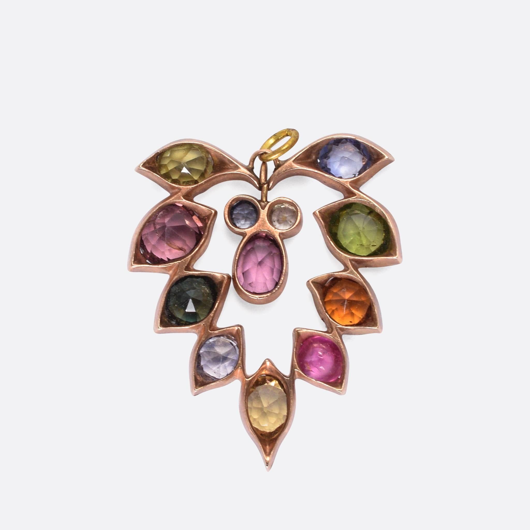 A sweet Victorian multi-gem pendant, set with a variety of natural coloured gemstones. The outer stones rest in stylised 