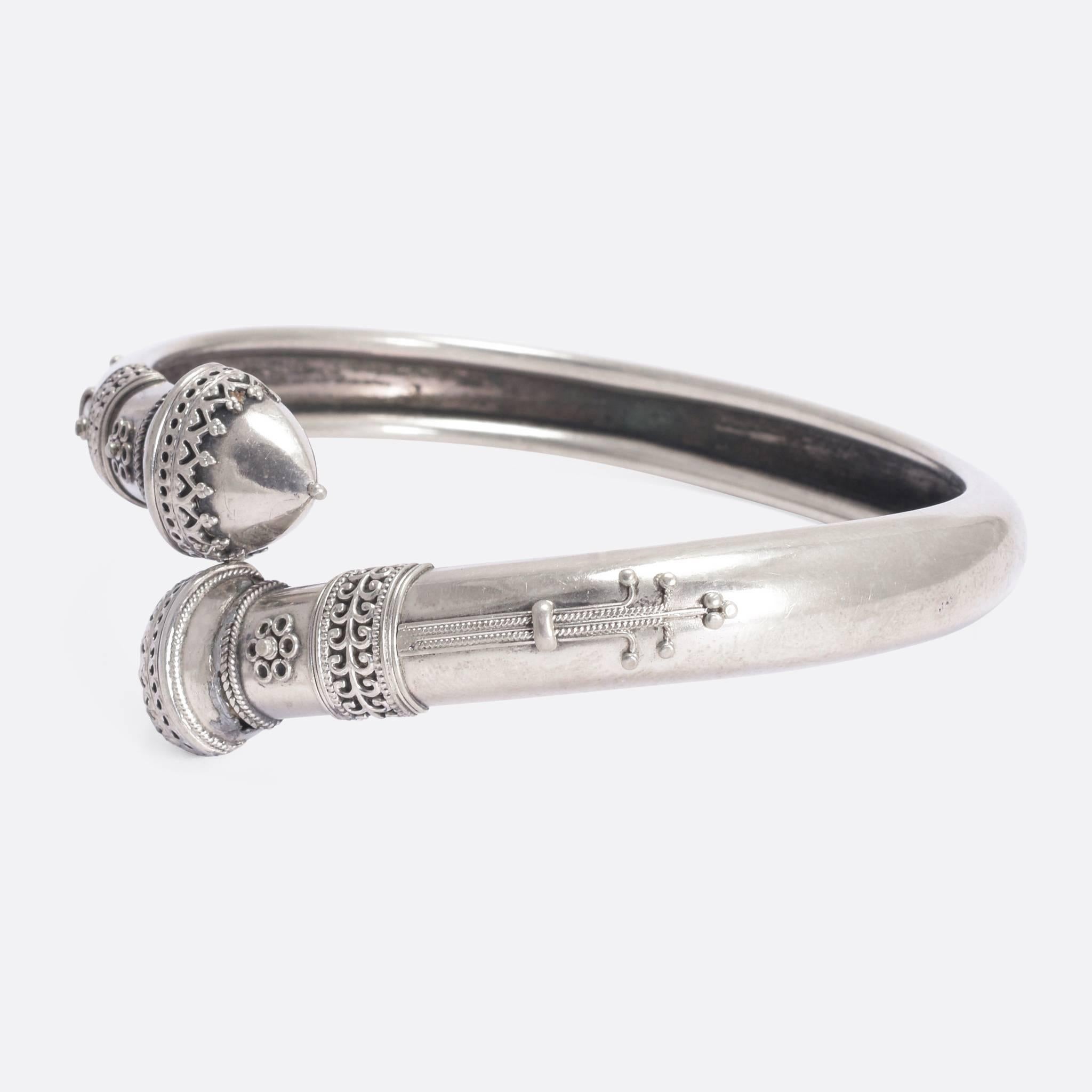 An unusual, and exceptionally lovely antique bangle in the Etruscan Revival style - dating to c.1880. It's crafted in solid silver, and features two acorns, beautifully adorned with intricate applied silverwork.
The Etruscan Revivalist movement