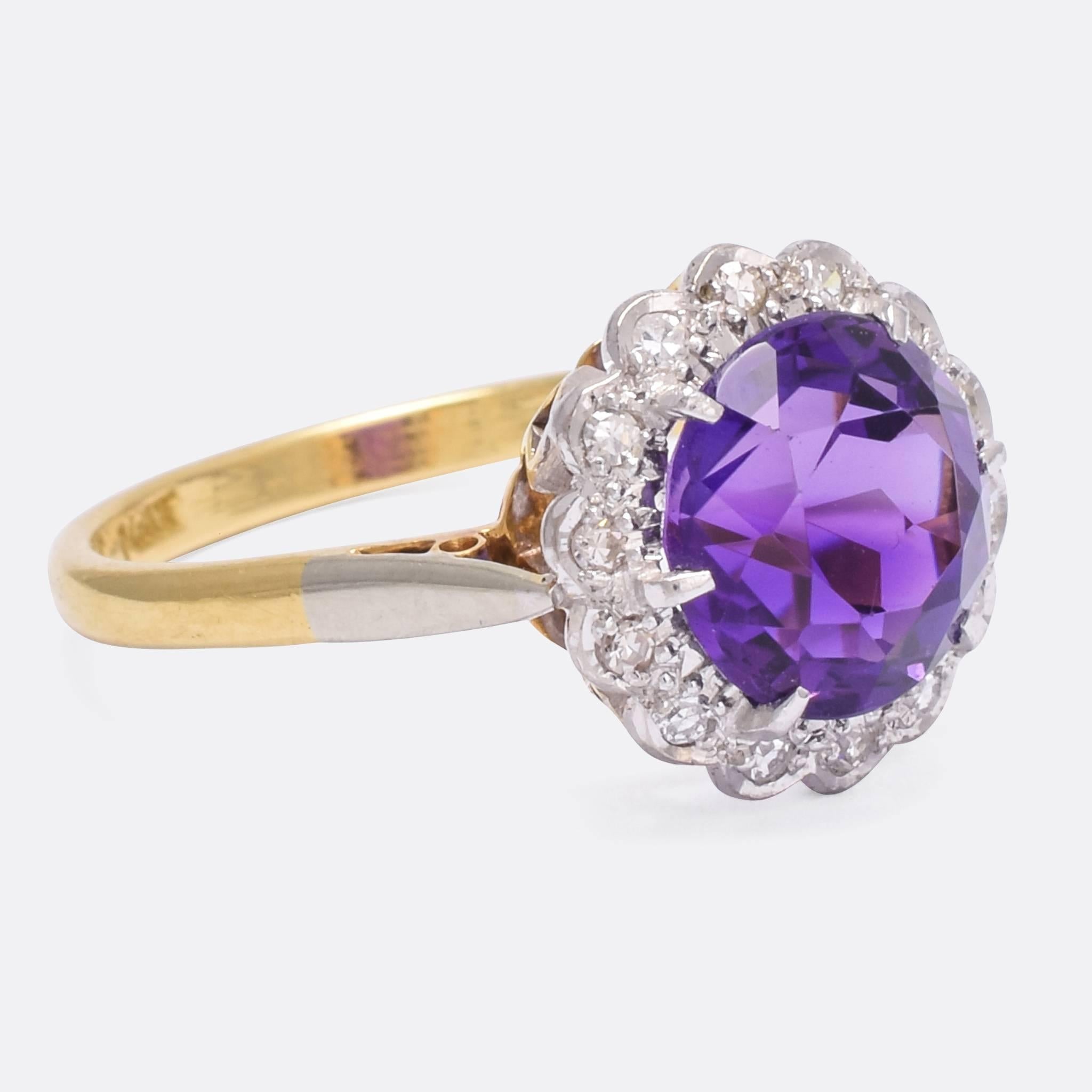 A lovely Art Deco era cluster ring, set with a vibrant Siberian Amethyst within a halo of platinum and diamonds. The ring features an unusual pierced gallery, that not only looks awesome, but allows light in behind the stones - further enhancing