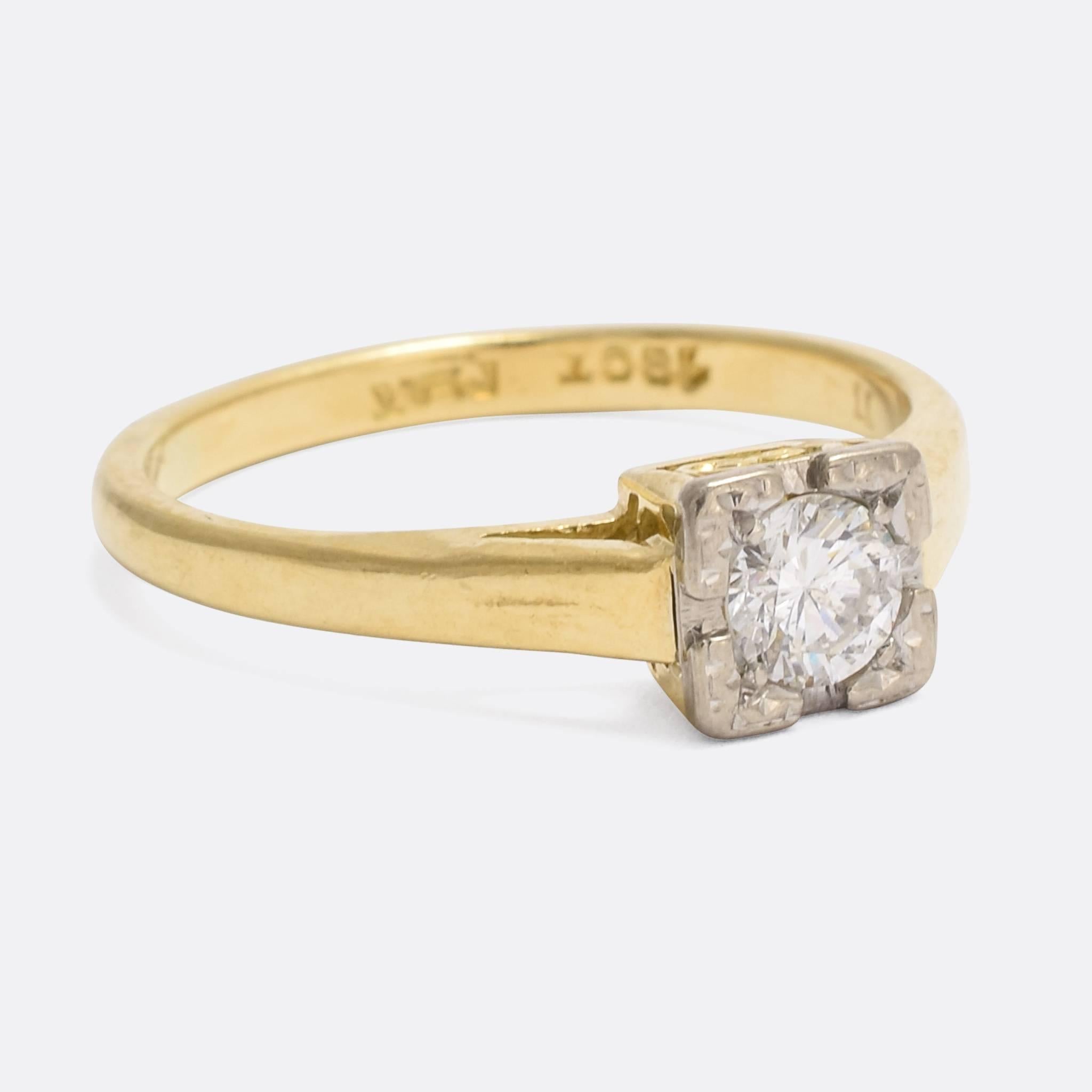 A sweet 1920s diamond solitaire ring, modelled in 18k gold. Set with a bright .35 carat brilliant cut diamond in a platinum tipped, square setting, the ring is dainty and elegant. With lovely scrolled detailing to the pierced gallery.

STONES
0.35ct