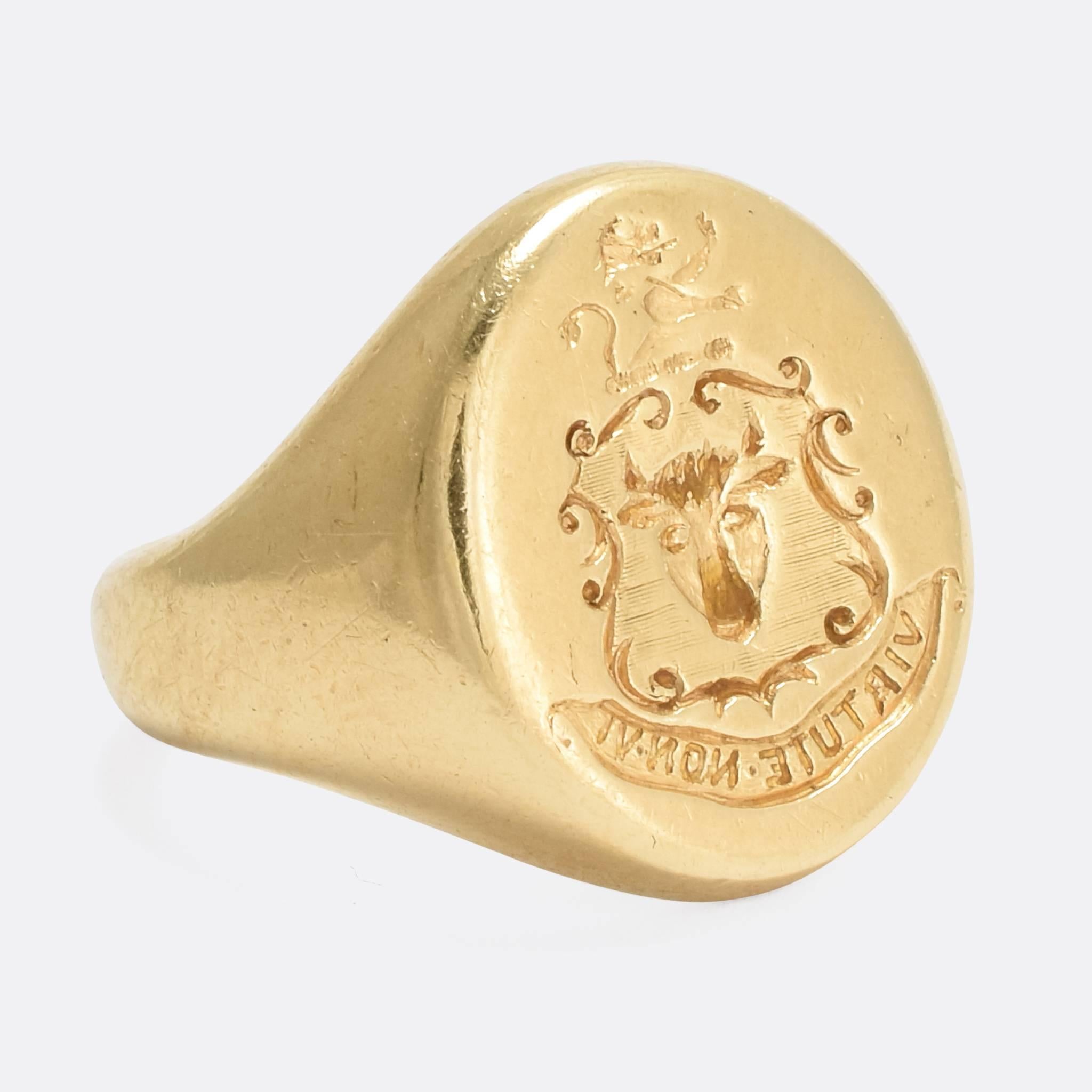 A classic oval faced antique Signet Ring, with intaglio carved heraldic crest. Depicted is a Bull's Head, beneath a Lion Rampant - all over the Latin motto: 