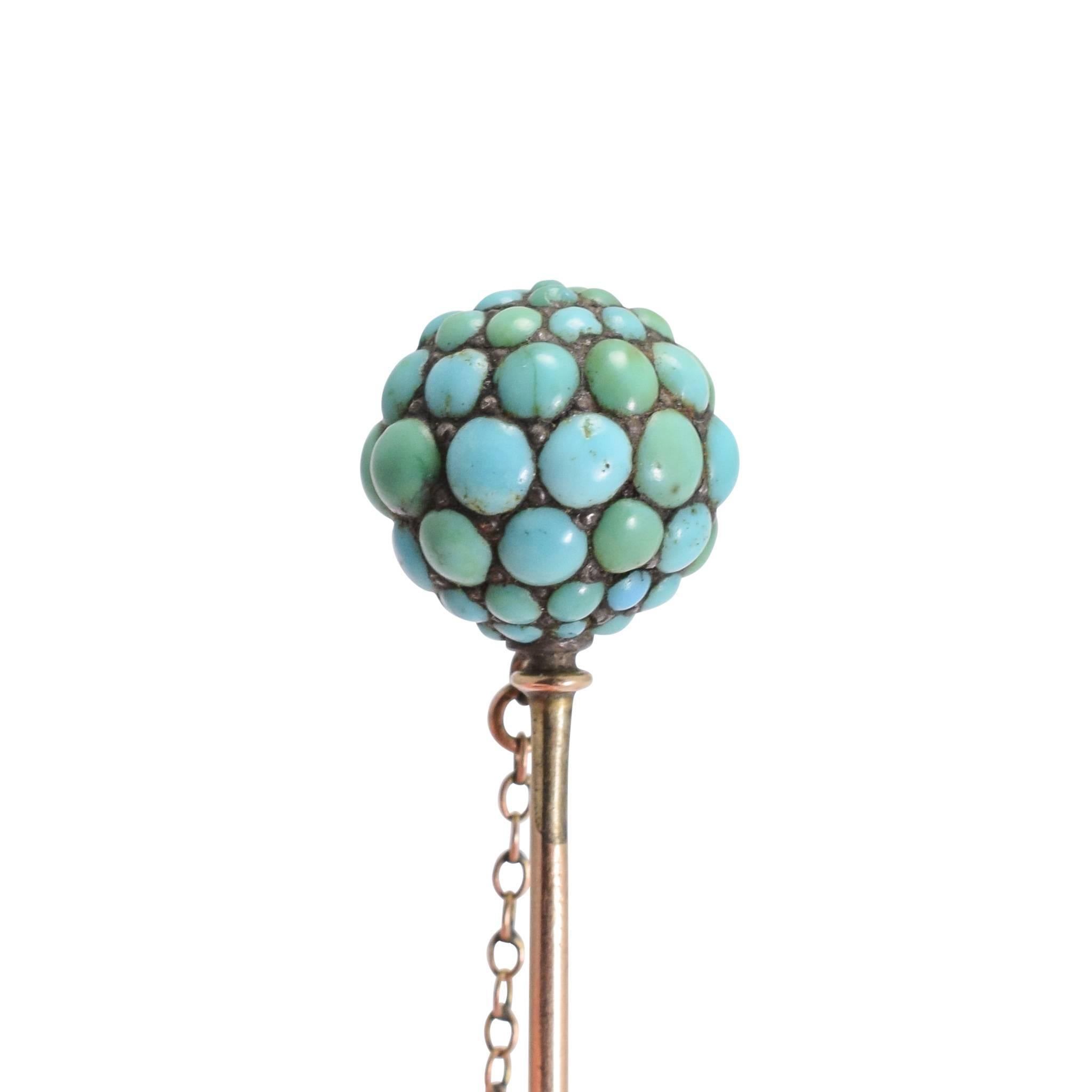 A cool, and sort of futuristic/alien looking, antique stick pin - the head is an orb set with graduated turquoise cabochons, each row getting smaller from the equator to the poles. The pin is 9k gold, and the stones set in silver that has oxidised
