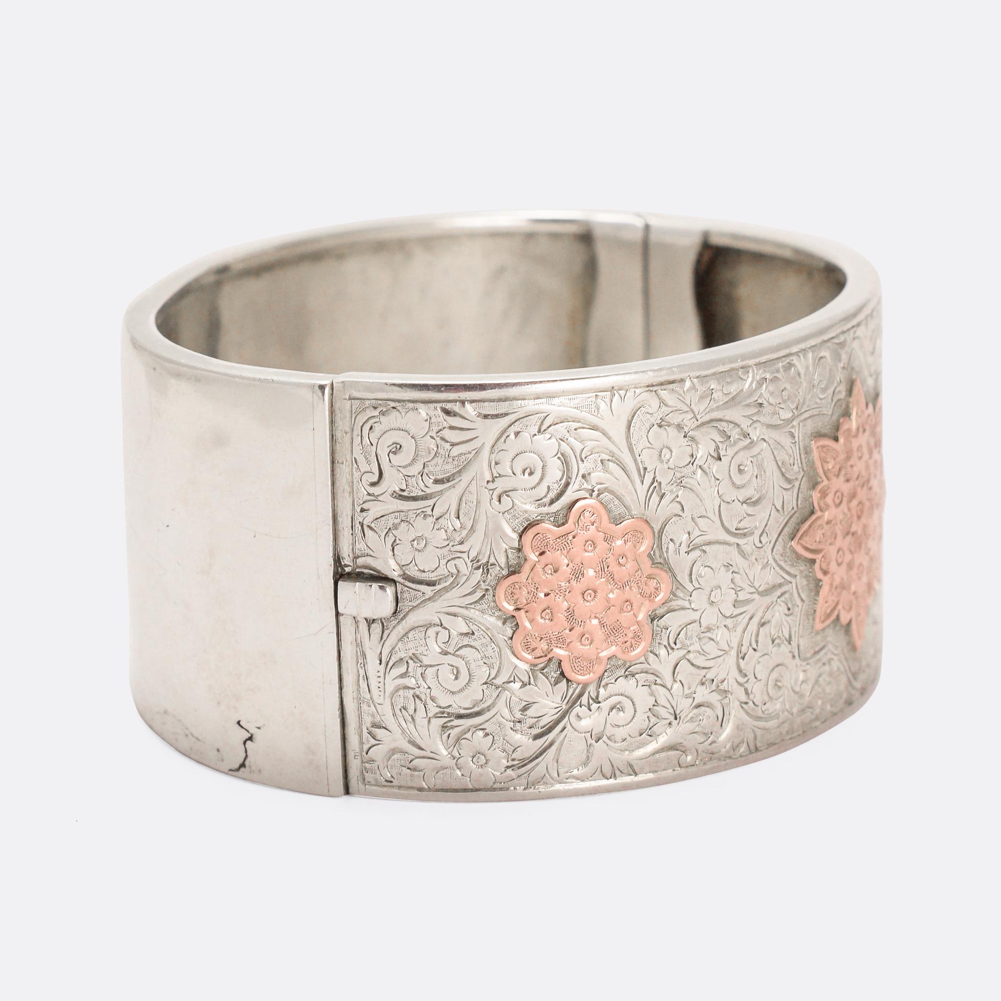 A fine quality antique silver cuff bangle featuring beautiful hand-chased detailing and applied rose gold flower motifs. The two tones of the antique metals complement each other perfectly; it's a particularly good example of this popular style.