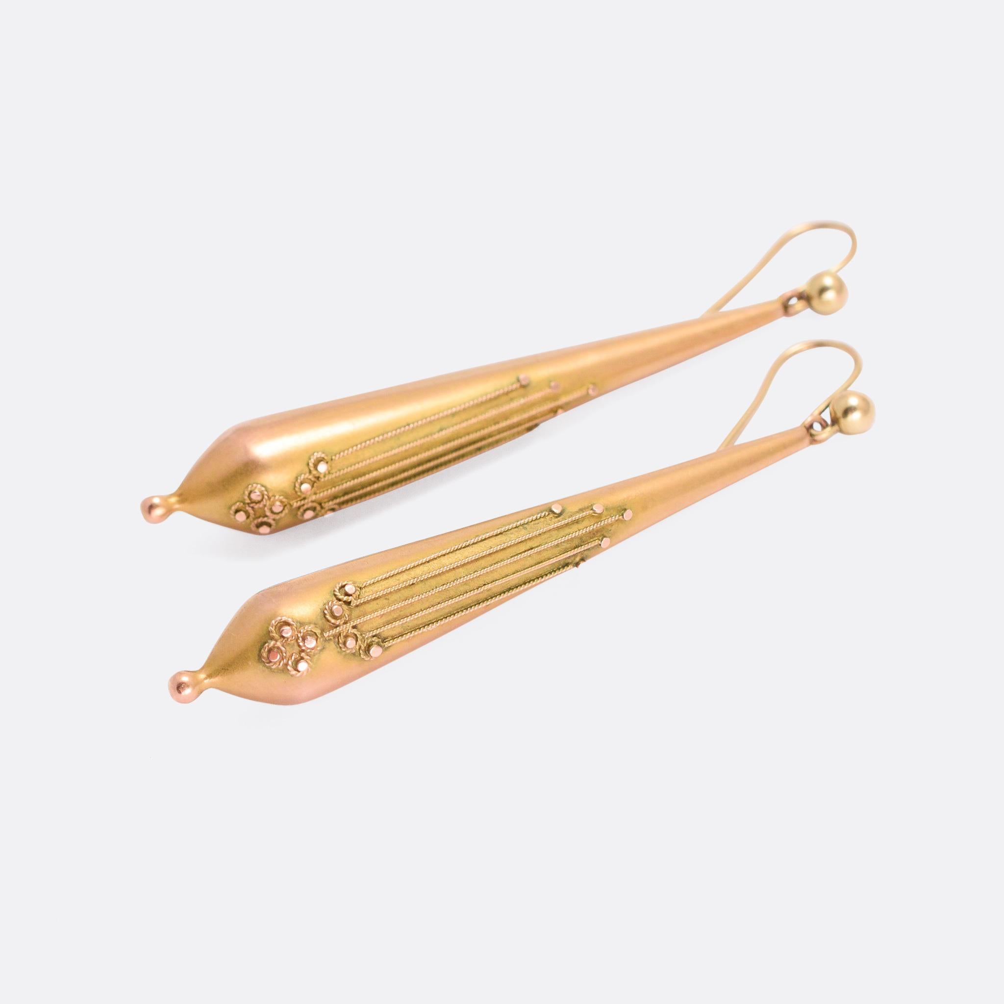A gorgeous pair of Etruscan Revival torpedo earrings crafted in 9 karat yellow gold. They feature applied ropework detailing, and have aqcuired a lovely antique patina over the years. They're a good size (5.7cm length) and date from the