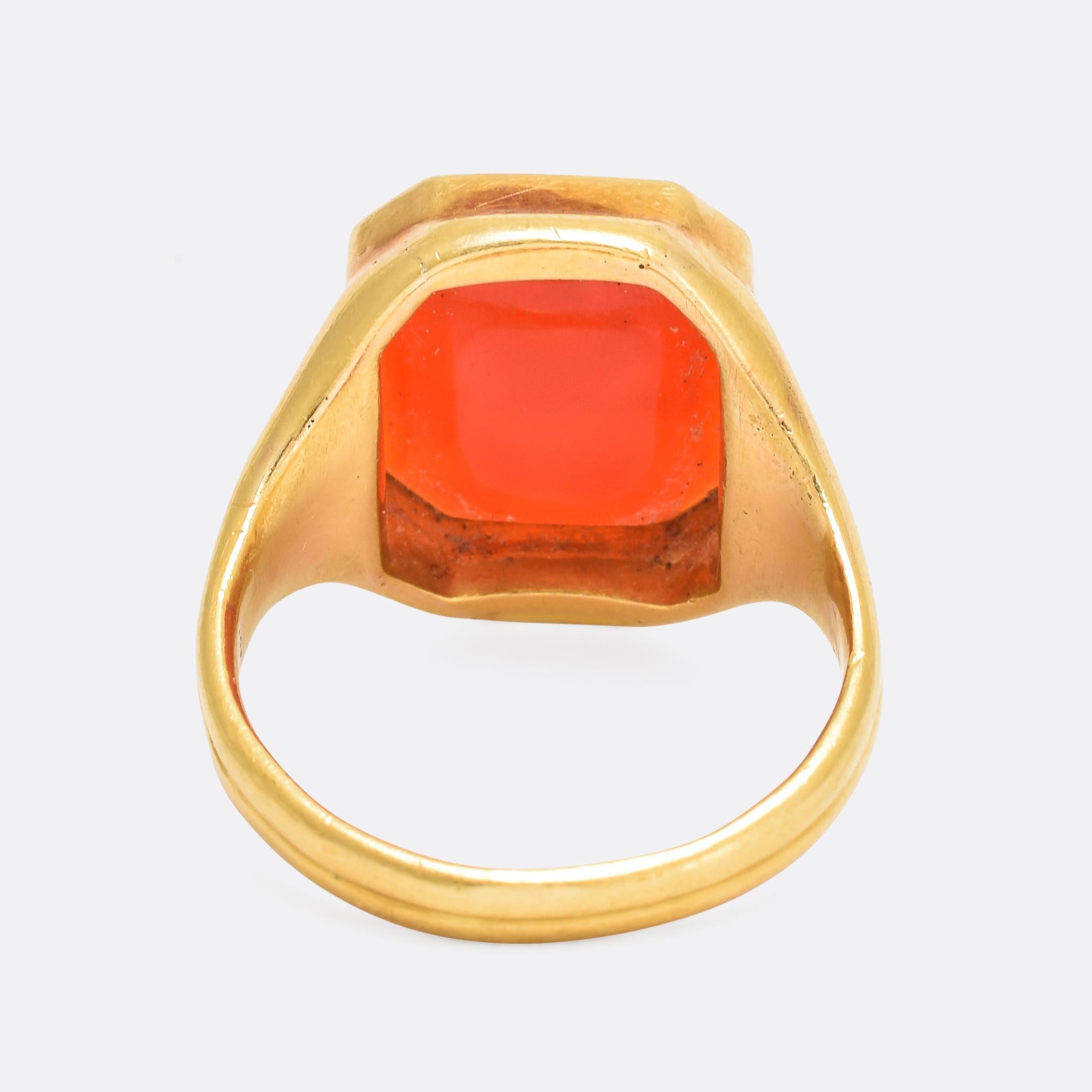 A cool antique carnelian signet ring, the face carved with an Elephant head intaglio above the initials IS. It has been reverse carved, allowing the wearer to stamp the crest into a wax seal. Modelled in 18 karat gold throughout, the piece dates