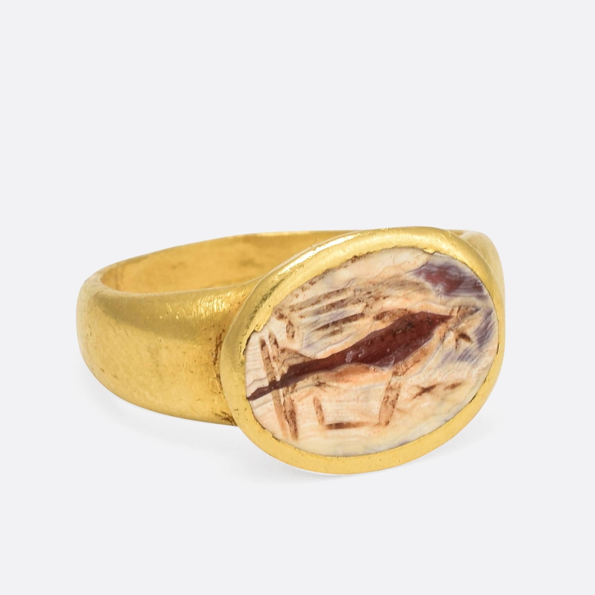 This incredible ring was made around 1800 years ago. The agate panel is carved with an intaglio depicting the Roman Goddess Victoria (or Nike in ancient Greek mythology). Victoria was the personified goddess of victory, and was a major part of Roman