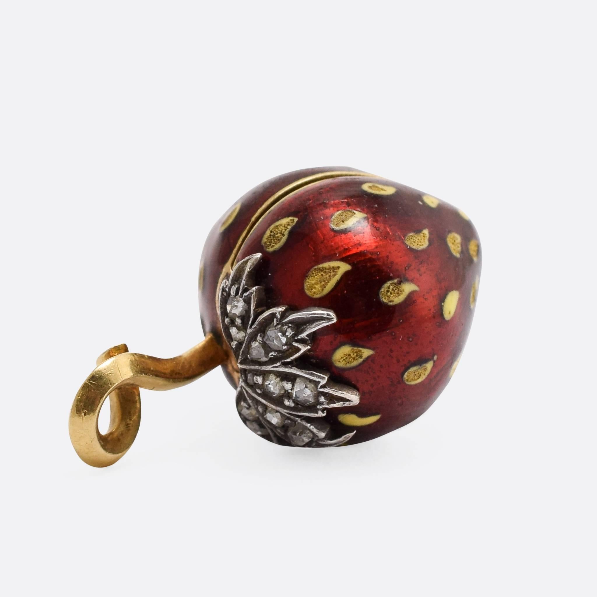 This incredibly cute antique strawberry locket was made in France in the late 19th Century. It's modelled in 18ct gold and finished in mouth-watering red enamel with diamond-set leaves. The top is hinged, and opens to reveal a compartment for an
