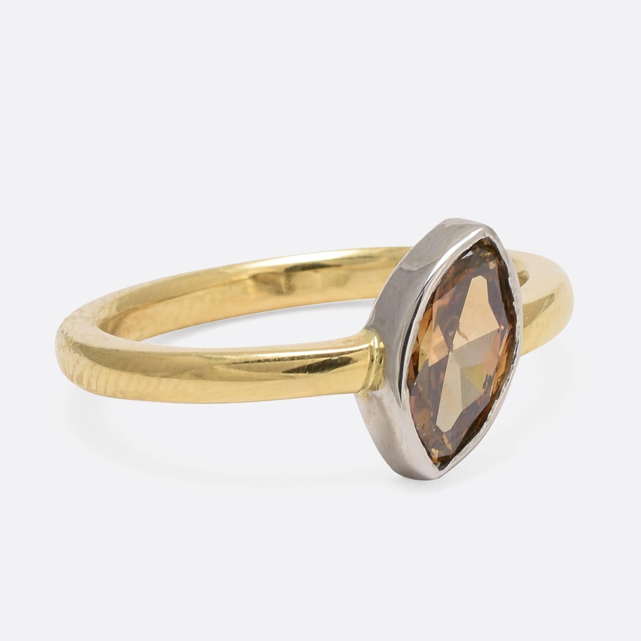 We have set this unusual vintage diamond in a contemporary ring mount of our own design. The moval cut stone weighs .81ct, and is a gorgeous cognac brown colour. The simple collet setting accentuates the unusual shape of the stone, which is itself