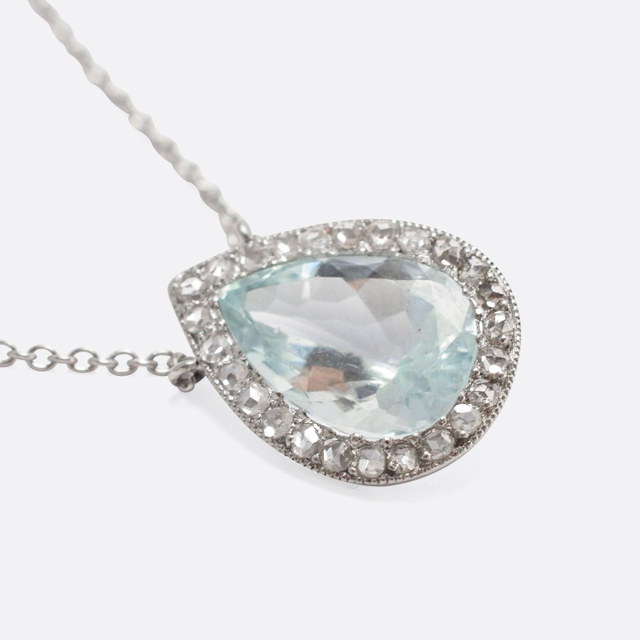 A sublime antique pendant, set with a pear cut aquamarine within a halo of diamonds. The settings are finished in fine millegrain detailing, and the piece modelled in platinum throughout - mounted on a fine platinum chain. It's refined and