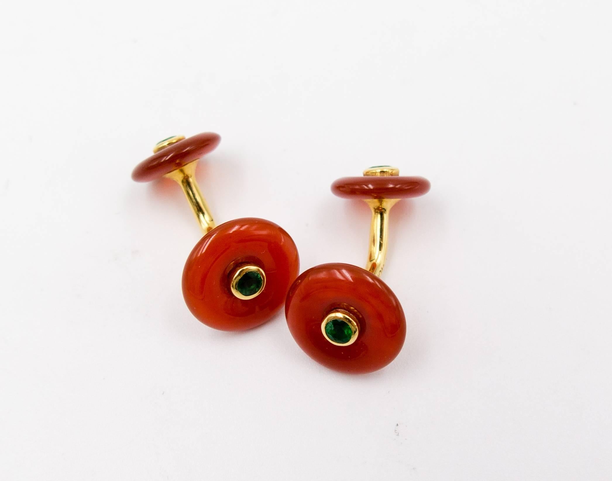 A perfect visual contrast between the burnt orange of the carnelian wheels and the bright grass green of the faceted emeralds (and they are far brighter and richer green than as pictured) will accent any shirt sleeve.  They're crafted of smoothly