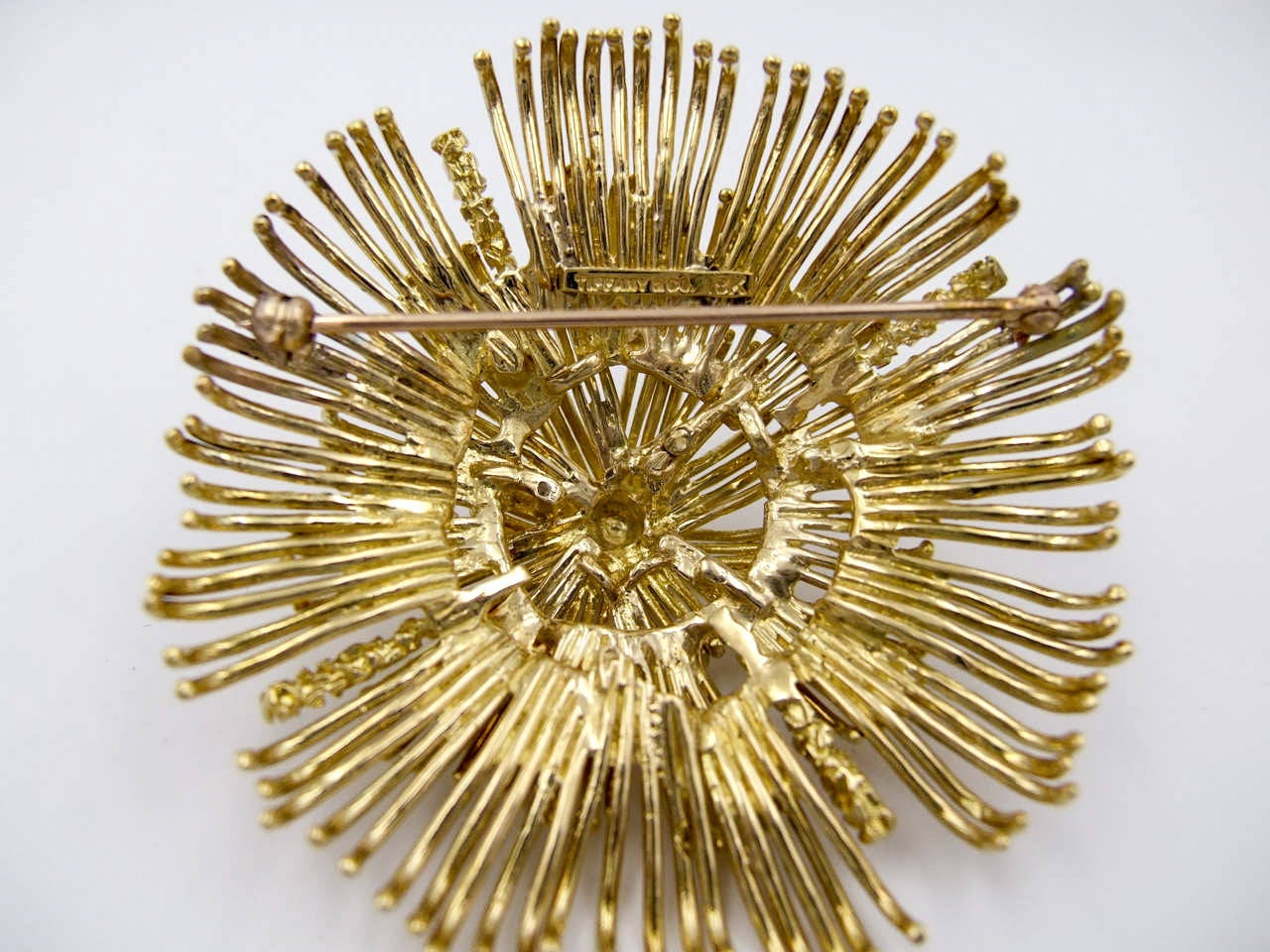 Bold 18 karat gold Tiffany & Co brooch, typical of those from the 1970s, possibly designed by Don Berg for Tiffany; the four rods of heavily textured gold are typical of his work.    It spans 2 1/4 inches across, and will be a statement piece on any