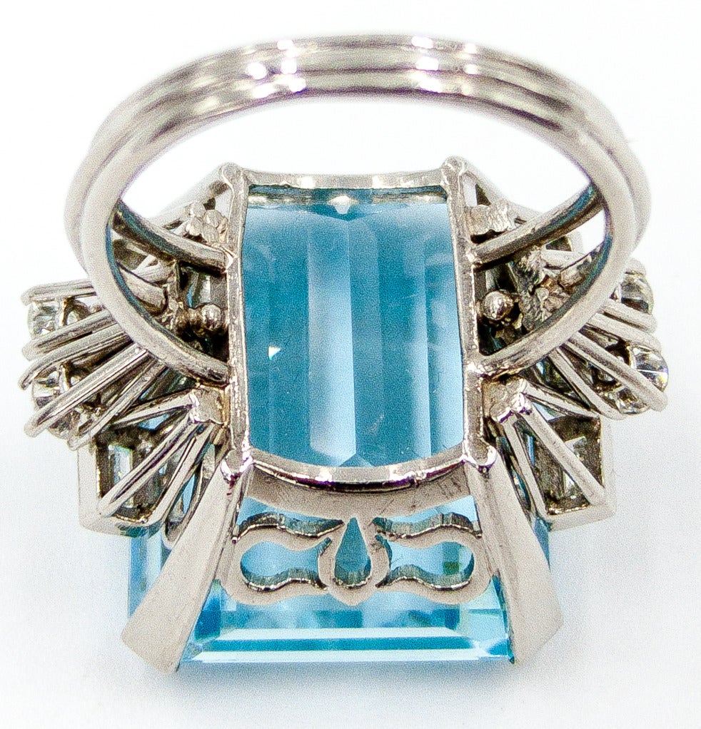 An elegant and wearable aqua and diamond ring, with a fine pastel aqua of approximately 35 carats, accented by a sprinkle of baguette and round diamonds at the sides.  The actual color of the aqua is a bit softer than as pictured; it's one of those