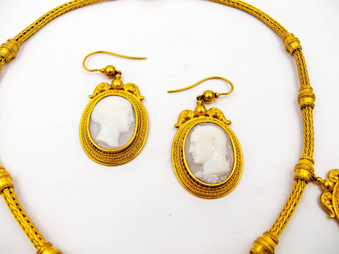 An elegant and wearable suite for the cameo lover.   Four different orientations of handworked gold wire surround each cameo.   The cameos themselves are of translucent chalcedony, allowing the light to filter through and illuminate each face, and