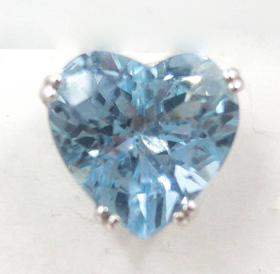  A practical pair of earrings for the aquamarine devotee's consideration.   These handcrafted platinum mounts hold a charming pair of fine color, heart-shaped aquamarines (weighing about 6 1/3 carats total) that can be worn on their own;  for