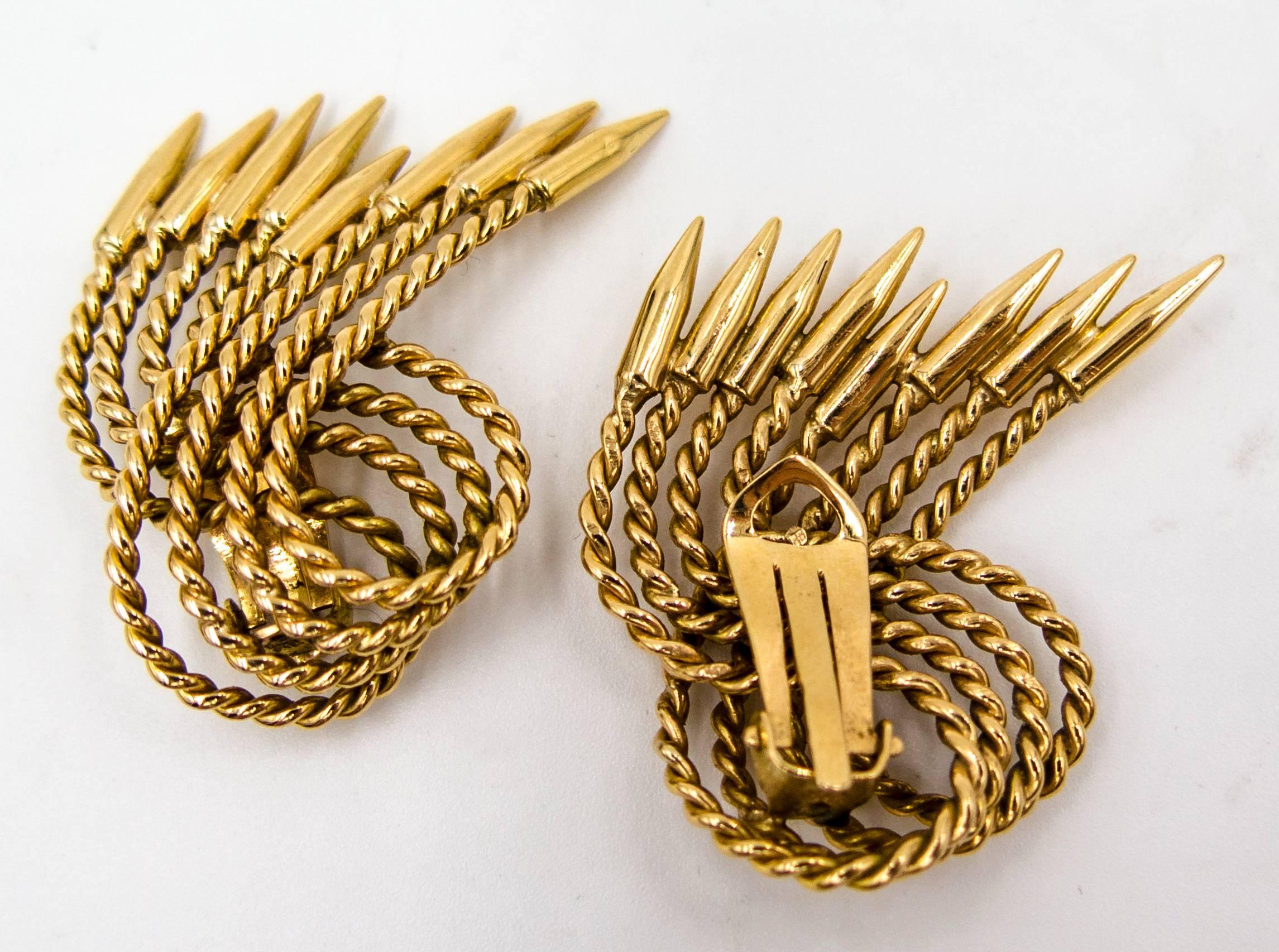   These elegant earclips in 18 karat gold can be worn in either direction - sweeping towards the face or facing outwards.  An interesting alternative use could be as dress clips positioned at the edge of a blazer or neckline.  Stamped 18 K at the