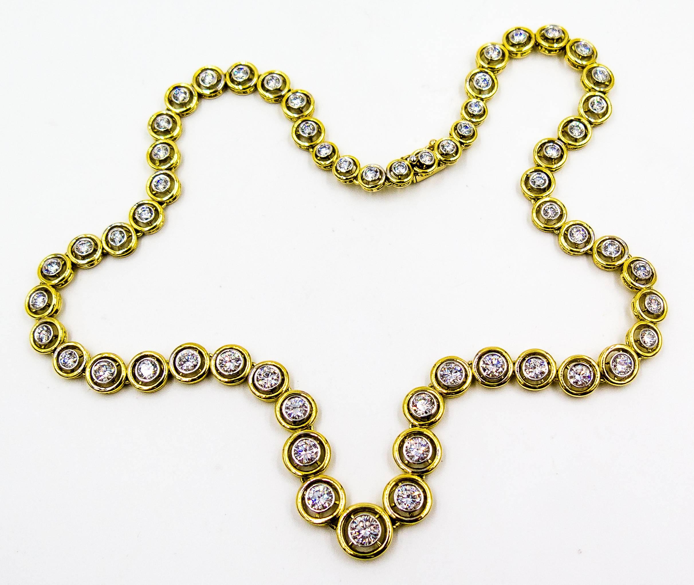   A beautiful and wearable diamond necklace of graduated diamonds - all clean and white in color - with each stone encircled by a frame of gold.   The necklace is set in 18 karat yellow gold, and the total diamond weight is approximately 11 1/2