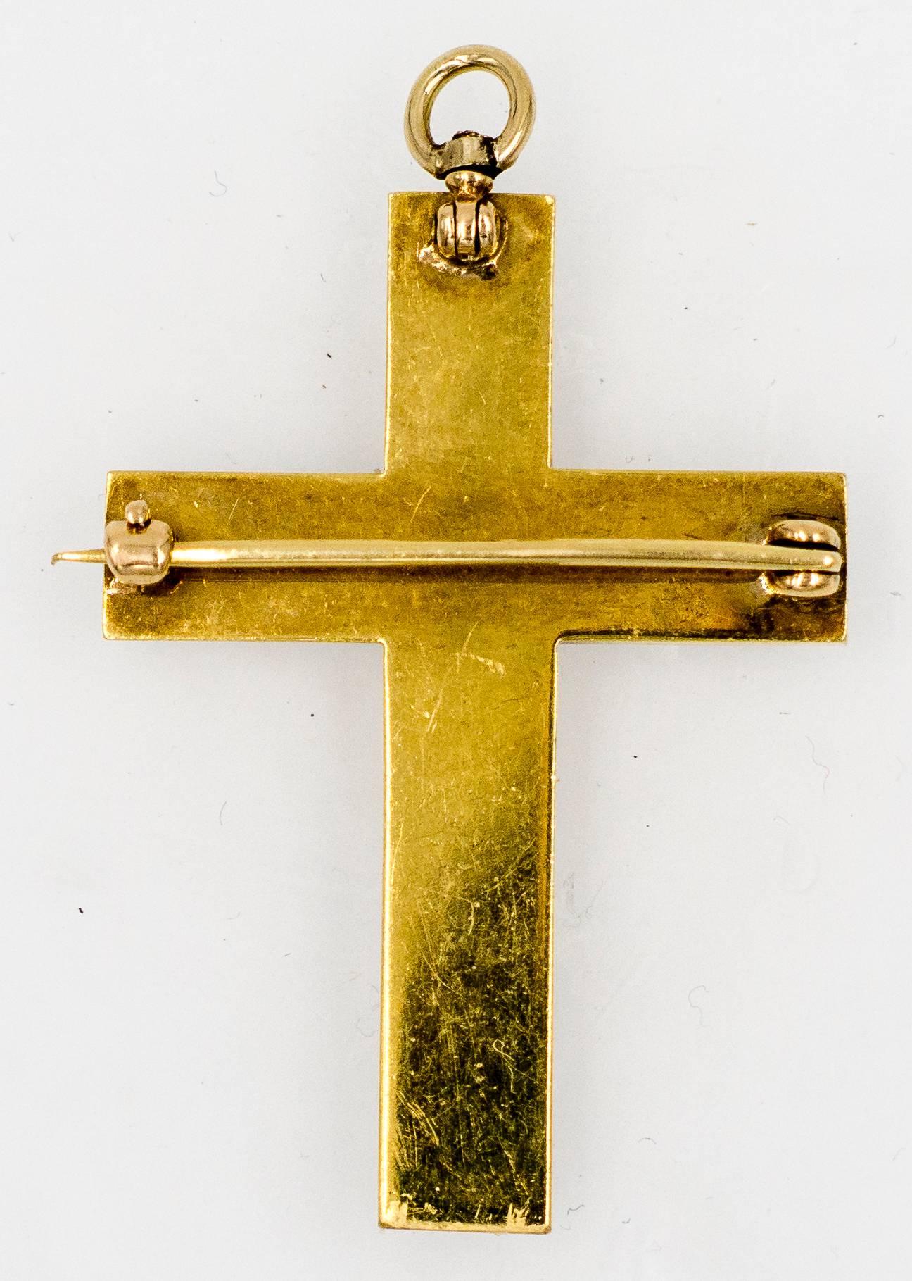  Classic and elegantly simple split pearl and gold cross that can be worn as a pendant or a brooch.  It measures 1 3/4