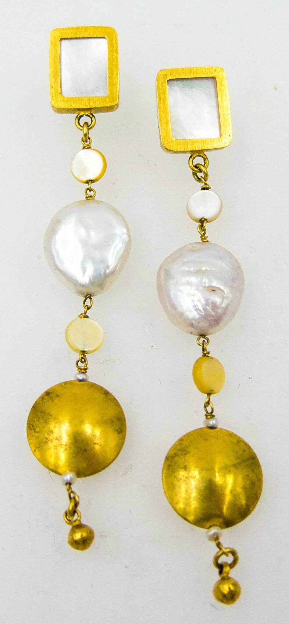 Three and a quarter inches long, these earrings would be a great addition to anyone's jewelry wardrobe.   Subtle and warm, the buffed finish of the gold is a pleasing contrast to the whiteness of the mother of pearl slices and the large freshwater