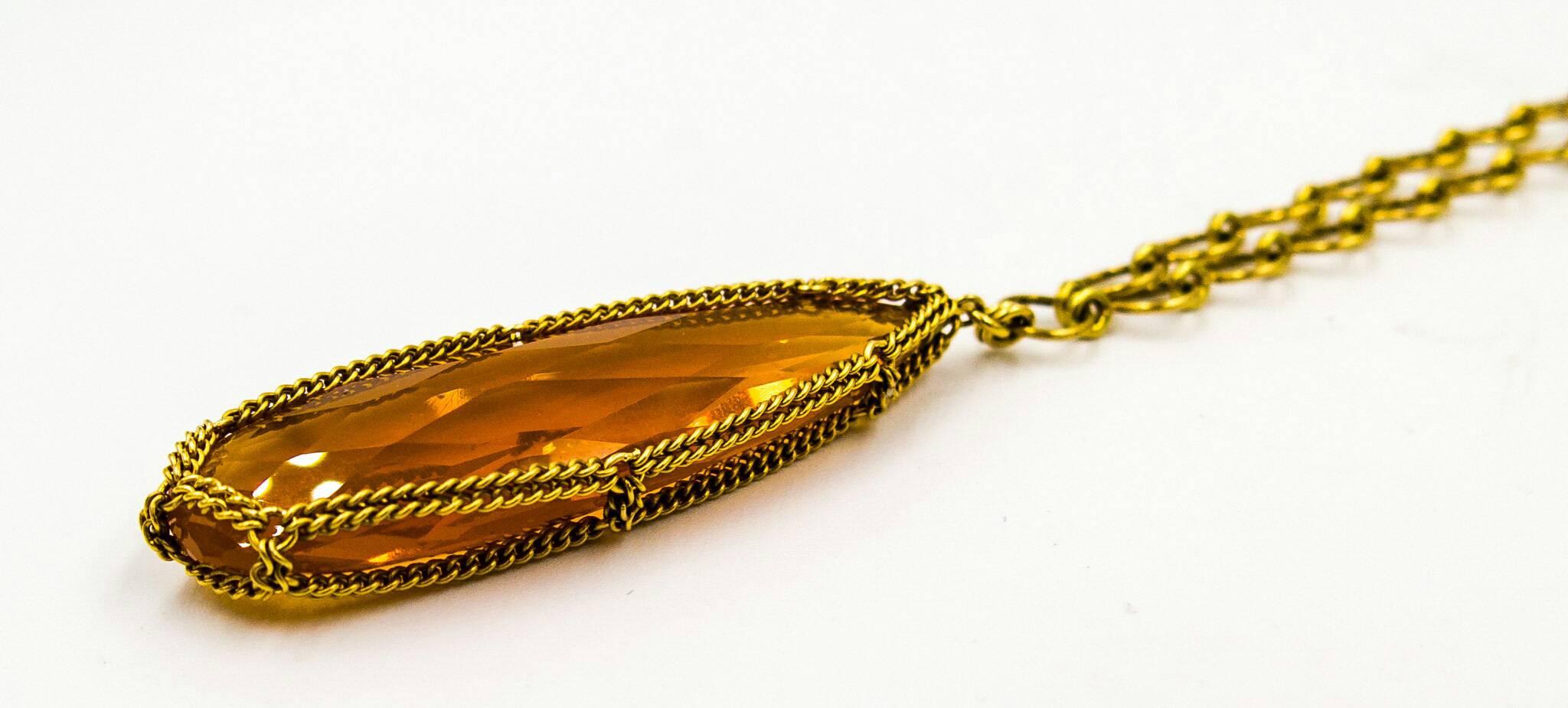    A large, vibrant teardrop Mexican fire opal ( a truly brilliant hot orange, much more so than in the image) hangs suspended from a rich colored 18 karat gold chain.   Many Nak pieces boast extensive use of micro gold chain, and this one is no