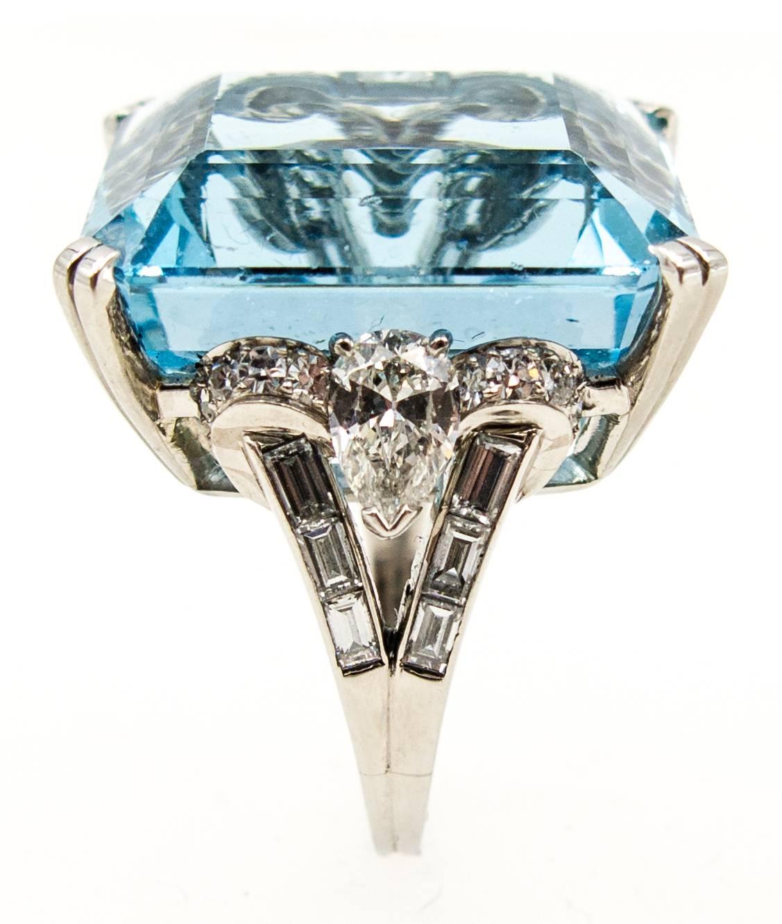 A truly one of a kind aquamarine and diamond ring for the discerning buyer.   A beautifully cut gem color, transparent turquoise blue aquamarine weighs about 32 1/2 carats, and is flanked at the shoulders with large, clean, white pear shaped