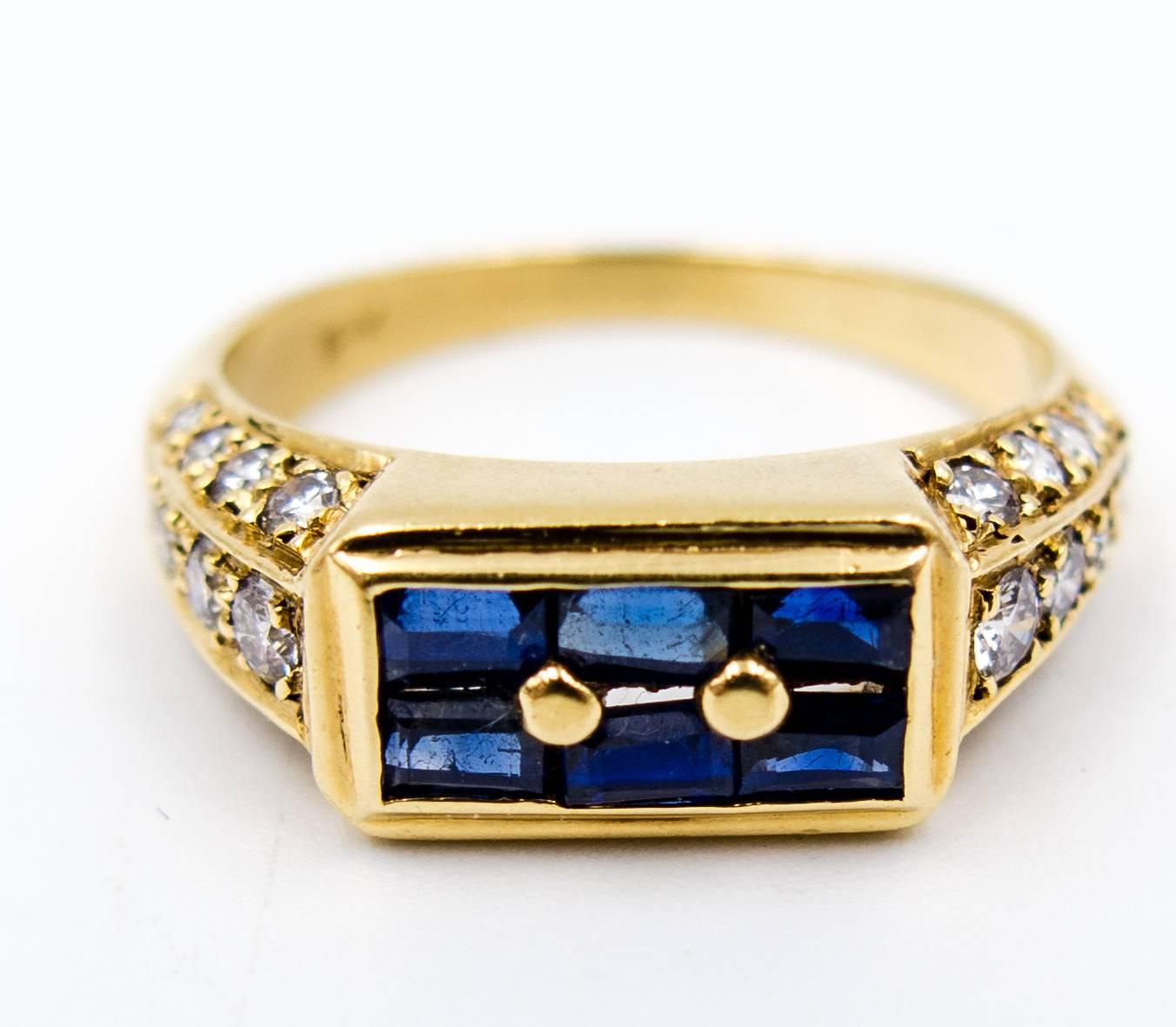 An eminently wearable sapphire and diamond ring simply because the setting of the stones has no visible prongs that can be accidentally lifted during normal wear.   Six rich color emerald cut blue sapphires sit at the top, anchored by small