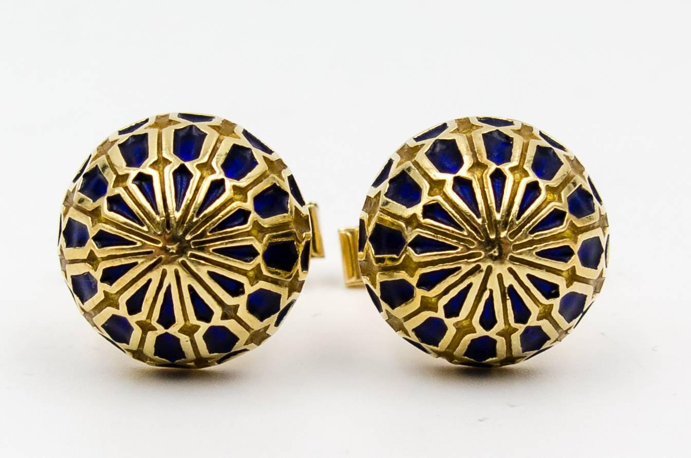 Cufflinks of 14 karat yellow gold accented with panels of deep, midnight blue enamel.  They're decorative and amusing and can be worn by women and men alike.  The dome of gold stands up 3/8