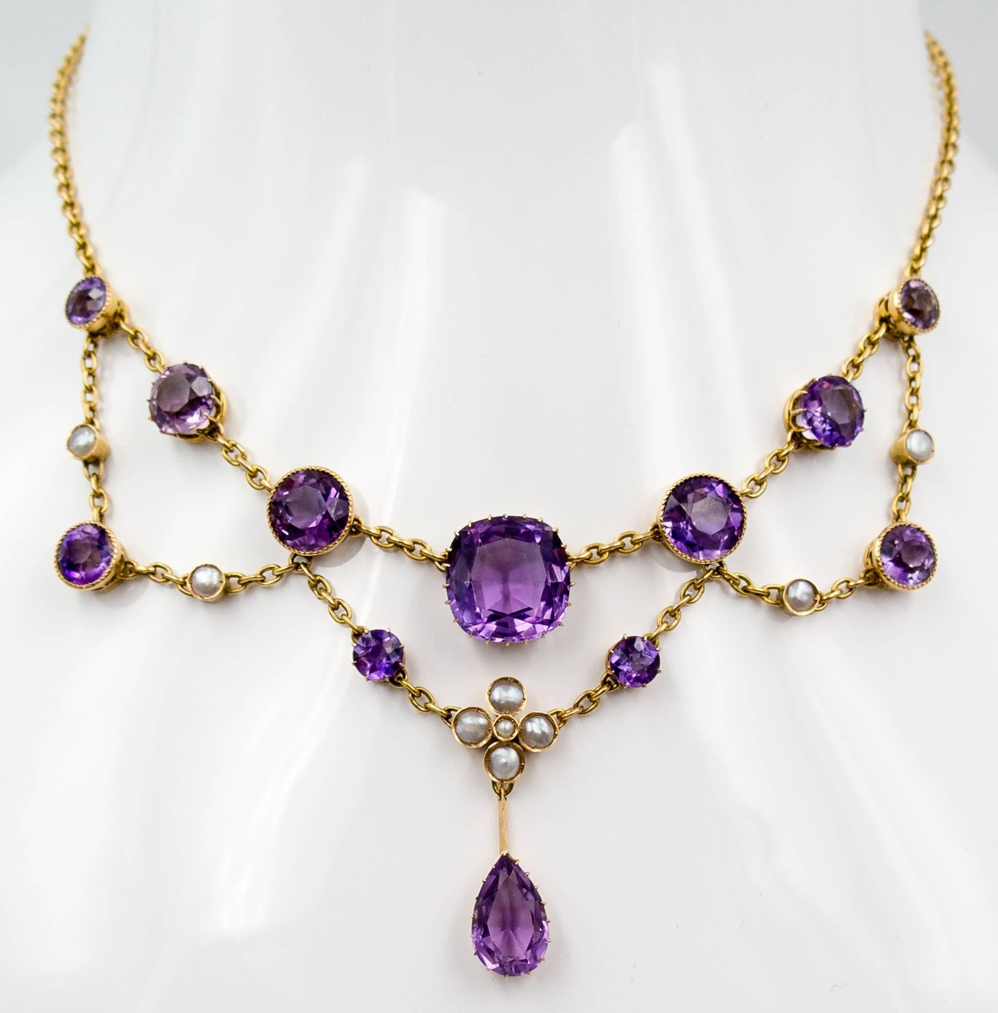 An elegant frame for any face, this lovely Victorian necklace consists of beautifully worked gold  chain linking both bezel and prong set pastel amethysts and pearls.  It measures 15 1/4" in length, and when fastened at the back, will