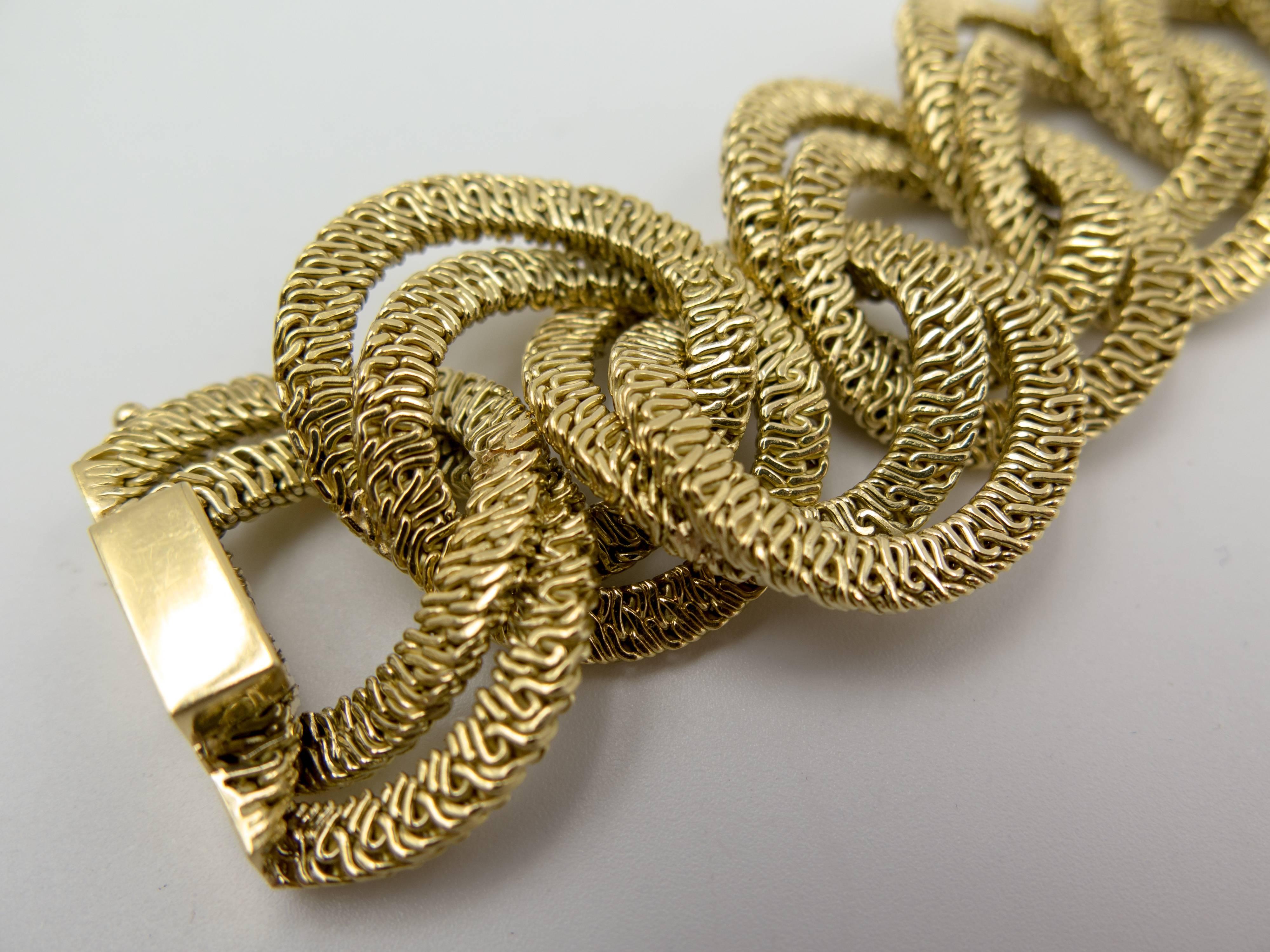 An elegant and extremely wearable gold bracelet to be worn day and night, destined to become someone's signature jewel.  Each link consists of tiny plaits of eighteen karat gold in curb link form, the bracelet measuring 8 1/4 " in length. 
