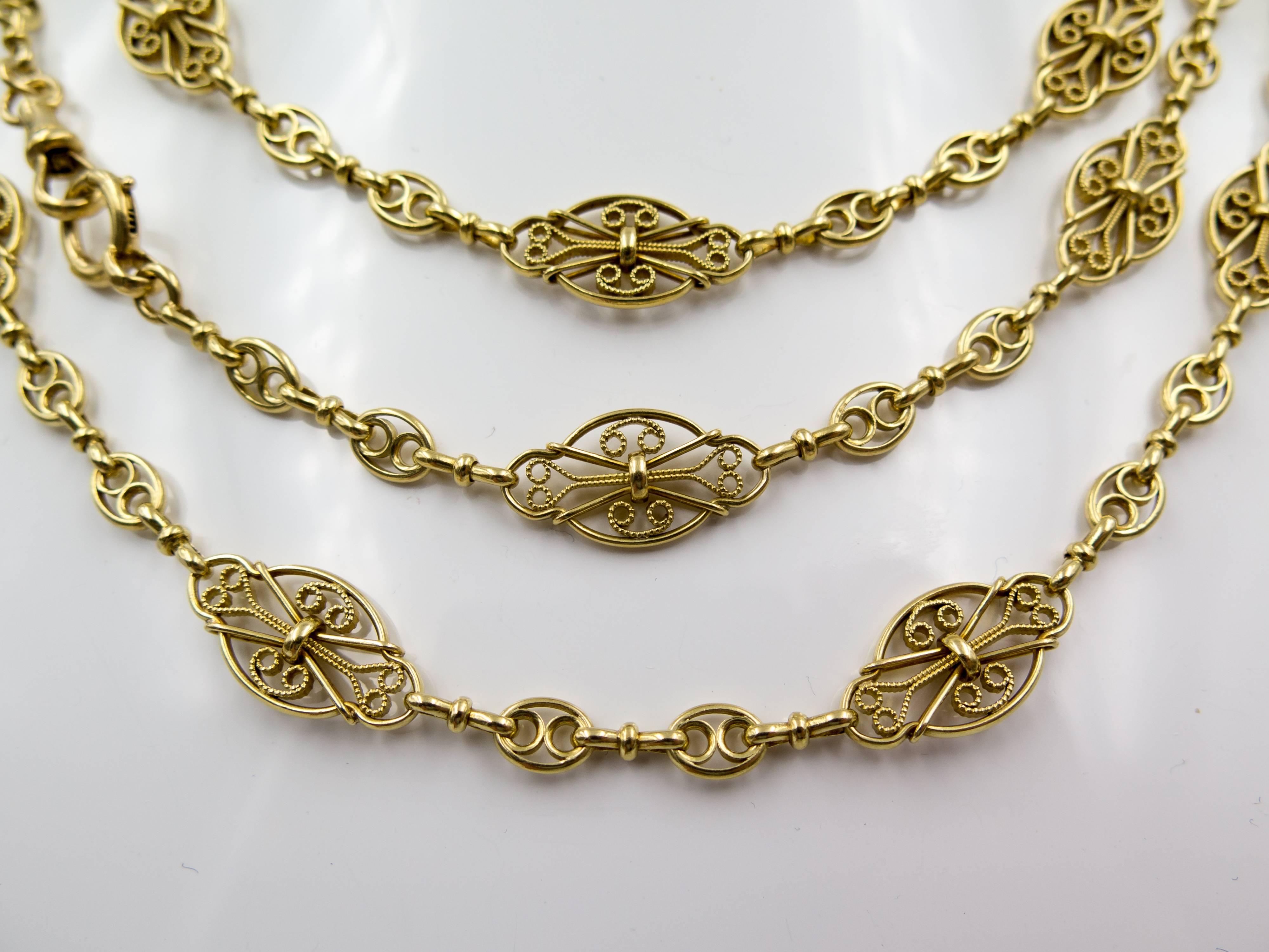  An exceptionally beautiful and detailed longchain, 60" total length, that can be worn single, doubled, or tripled (as pictured).  It can also be wrapped numerous times around a wrist as a luxurious bracelet.  The ornate scrolling within the