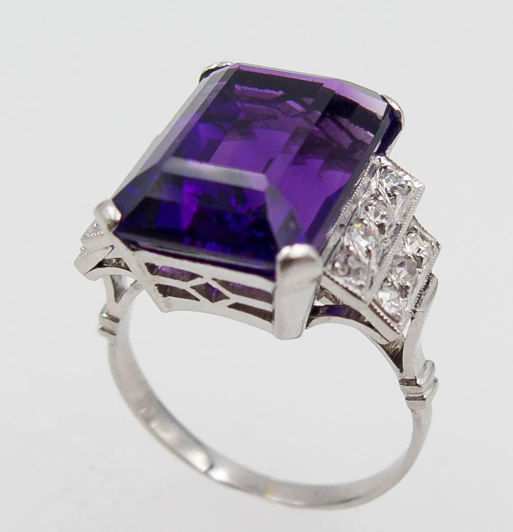 A lovely little amethyst and diamond ring in 18 karat white gold (tested not stamped).   The deep rich purple amethyst weighs about 8 carats, and is nicely accented by dual step-down diamond set shoulders, the 14 old mine cut diamonds totaling about