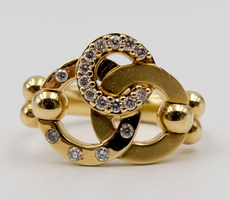 Three elegant circles of 18 karat gold set with diamonds in the inimitable Temple St Clair style.  The smallest circle is completely set with clean, white diamonds in a row, while a larger circle contains diamonds evenly spaced out and the third