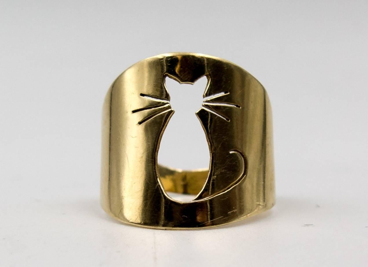 Cat lovers, take notice - this  adorable little ring can go with you everywhere, even if your beloved feline cannot.  It's the outline of a seated cat precisely cut into the 14 carat yellow gold with his whiskers swirling along each side.  His