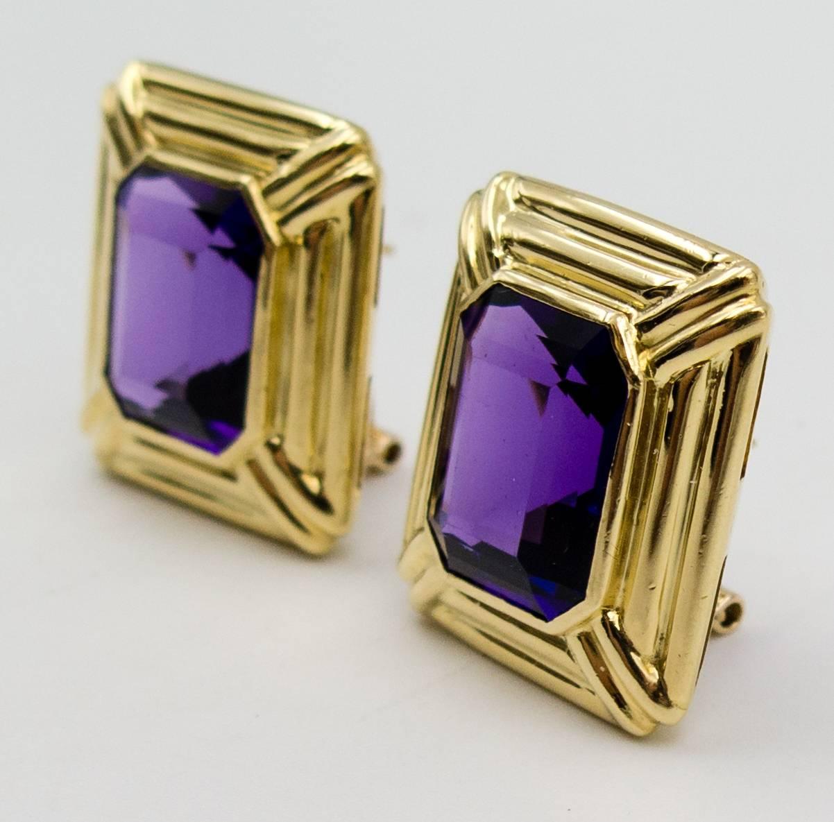 Sometimes simple is best, and these earclips fall into that category.   Large, excellent color deep purple emerald cut amethysts sit within a triple border 18 karat gold frame, and affix to the earlobe with a simple yet sturdy omega back.   The