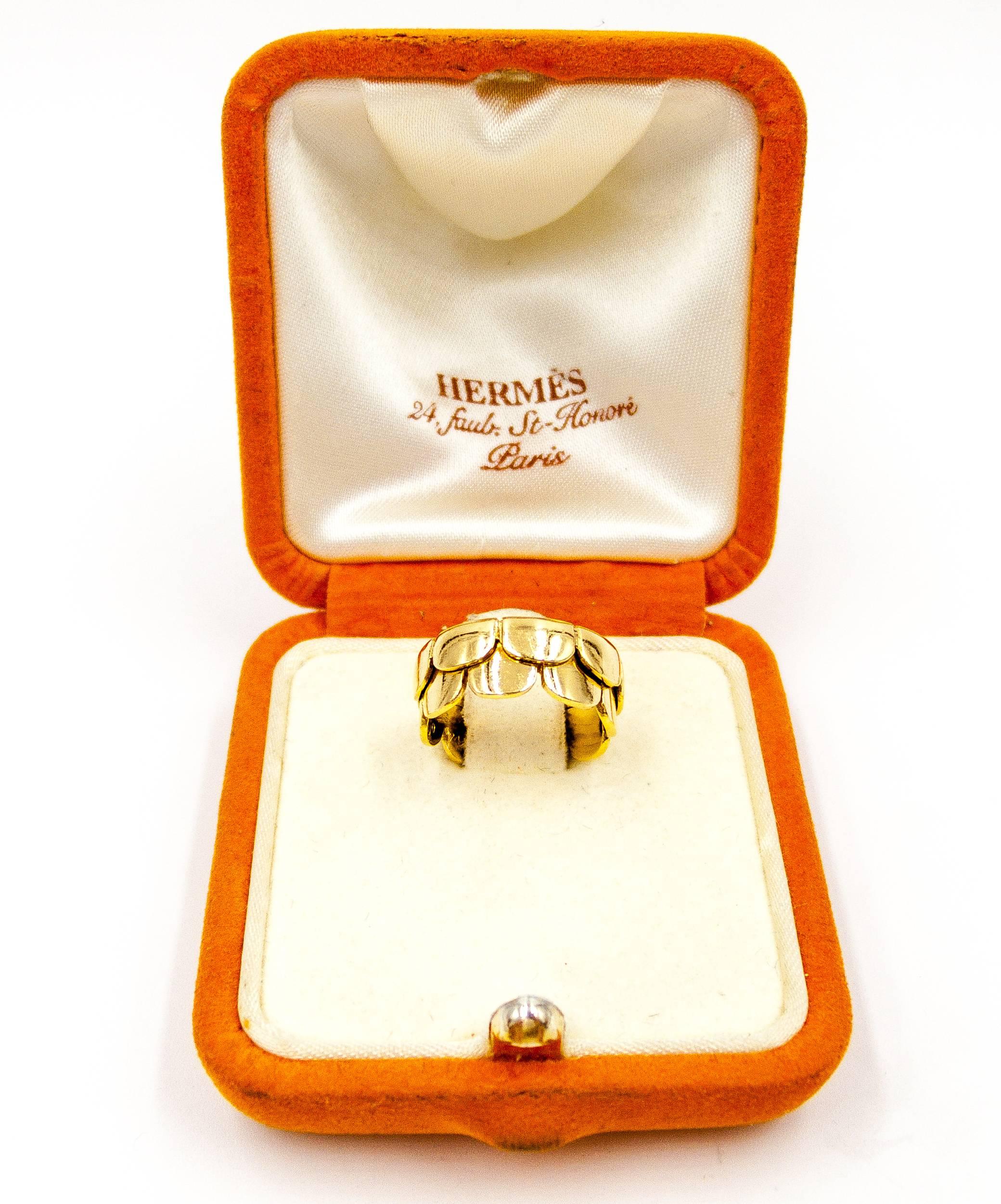 Perennially elegant and timeless, Hermes jewels display fine quality workmanship and inimitable French style in every item.   This lovely little ring consists of two rows of 18 karat gold scallops, to be worn facing in either direction.  Signed