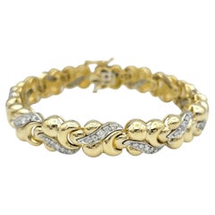 Bracciale con maglie curve massicce e diamanti in oro bicolore a 14 carati