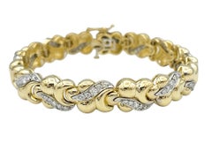 Bracciale con maglie curve massicce e diamanti in oro bicolore a 14 carati