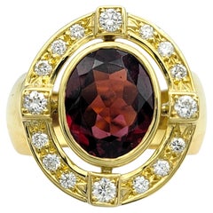 Oval Cut Garnet and Diamond Halo Ring with Wide Band in 18 Karat Yellow Gold