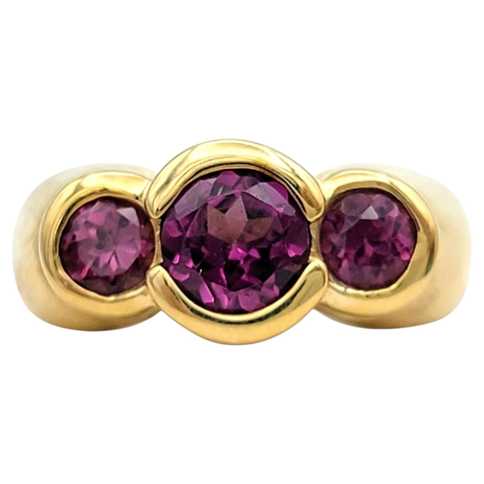 Bezel Set Garnet Three Stone Band Ring in 14 Karat Yellow Gold For Sale