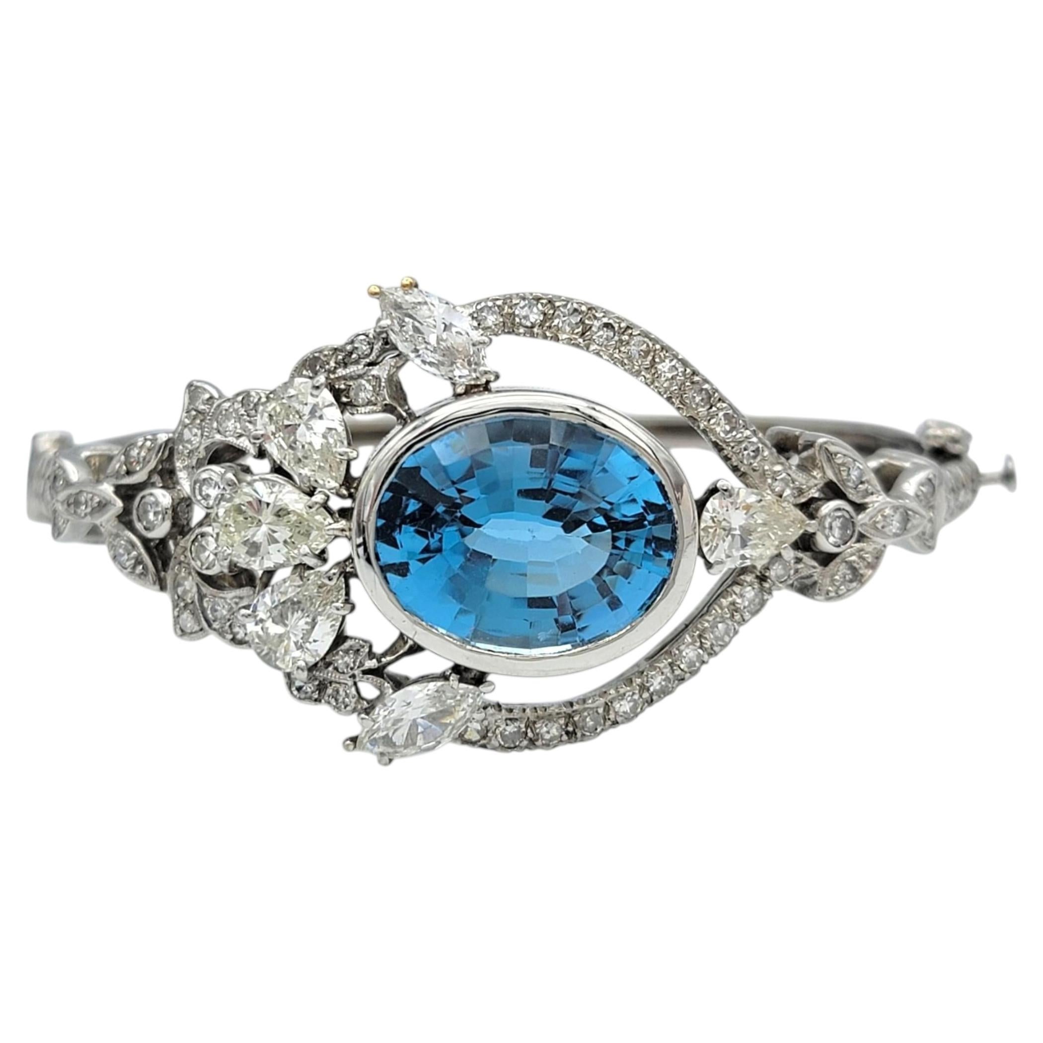 Oval Cut Blue Topaz and Multi Diamond Bangle Bracelet in 14 Karat White Gold