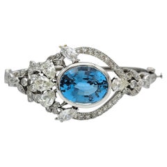 Oval Cut Blue Topaz and Multi Diamond Bangle Bracelet in 14 Karat White Gold