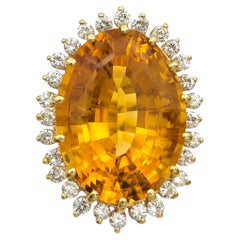 23.31 Carat Oval Citrine Cocktail Ring with Diamond Halo in 14 Karat Yellow Gold
