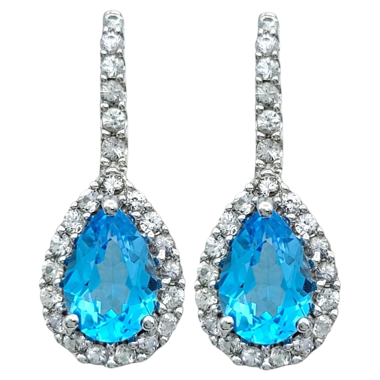 Pear Cut Blue Topaz and White Sapphire Halo Drop Earrings in 14 Karat White Gold