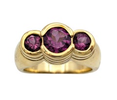Bezel Set Garnet Three Stone Band Ring in 14 Karat Yellow Gold