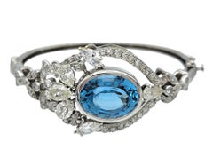 Oval Cut Blue Topaz and Multi Diamond Bangle Bracelet in 14 Karat White Gold