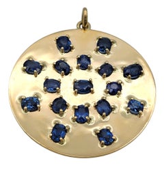 Large Circle Pendant with Oval Cut Blue Sapphires in 14 Karat Yellow Gold