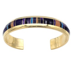 Bracciale a polsino con intarsio di pietre dure e diverse gemme in oro giallo 14 carati
