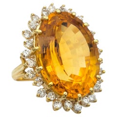 23.31 Carat Oval Citrine Cocktail Ring with Diamond Halo in 14 Karat Yellow Gold