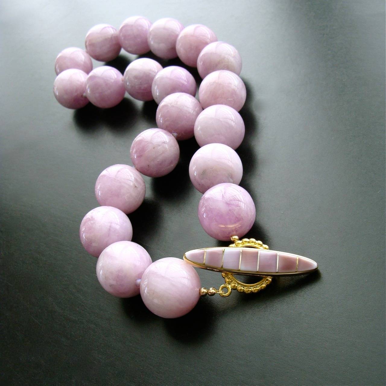 Kunzite gumball sized beads in a sweet orchid confectionary color, create a modern and feminine choker necklace.  The untamed nature of these stunning beads is a sophisticated juxtaposition when paired with the delicate lilac inlay shell gold